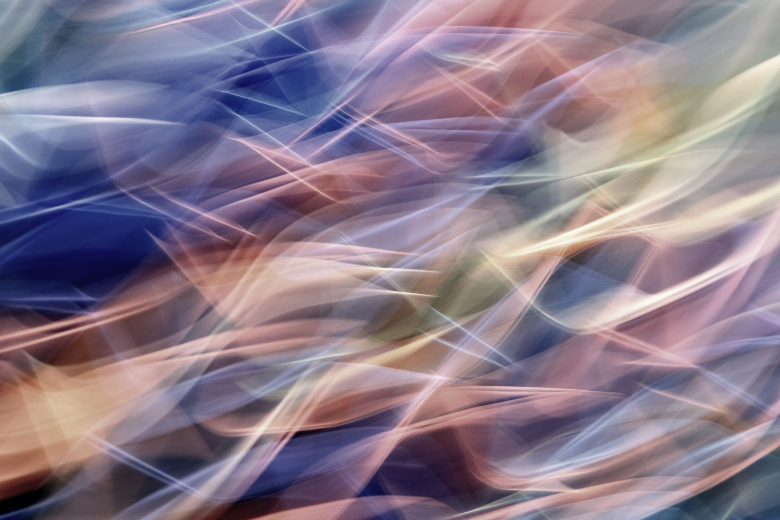 Abstract light trails in pastel colors with smooth flowing motion.
