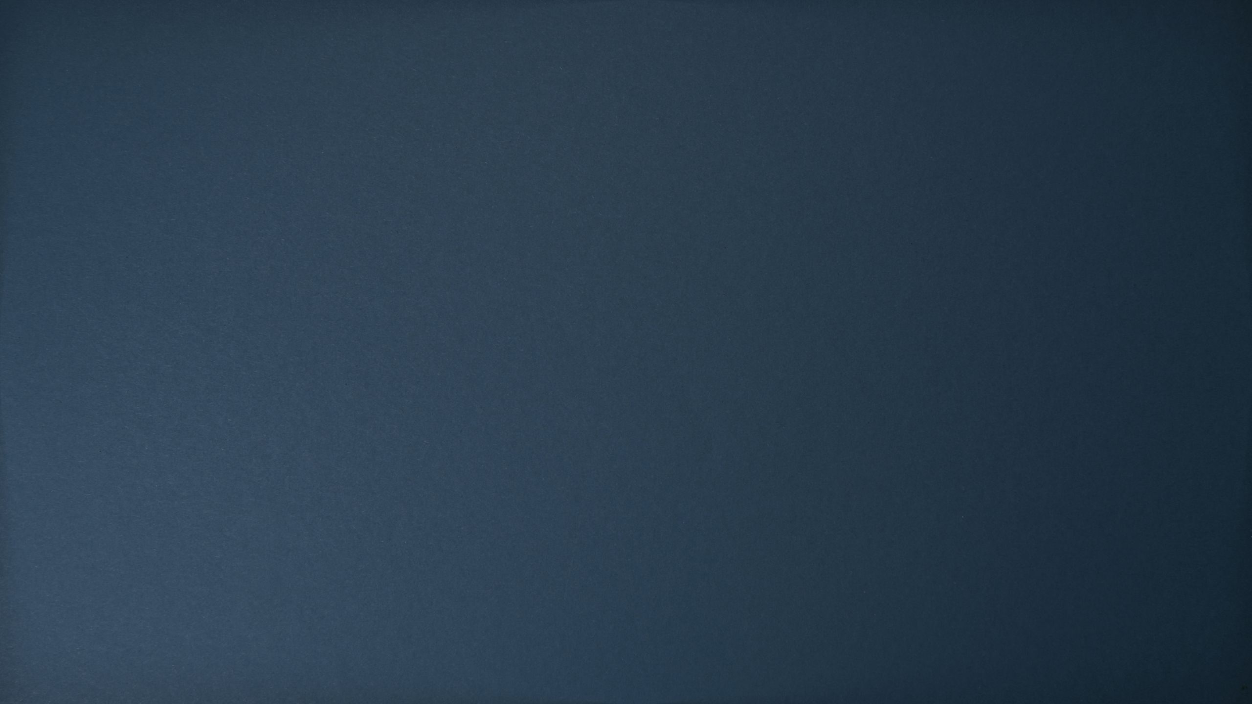 Dark blue textured background with subtle surface variations.