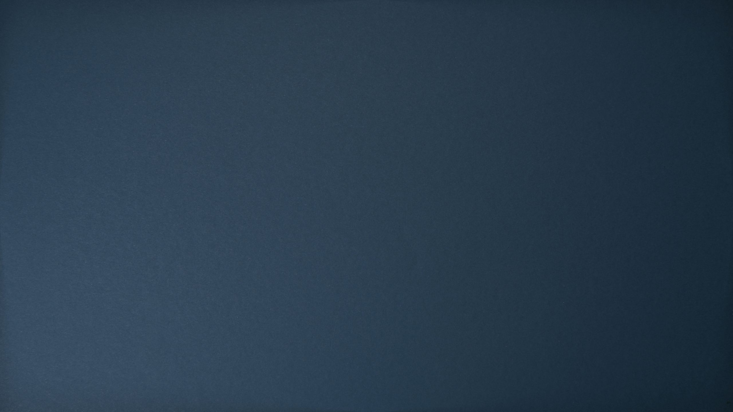 Dark blue textured background with subtle surface variations.